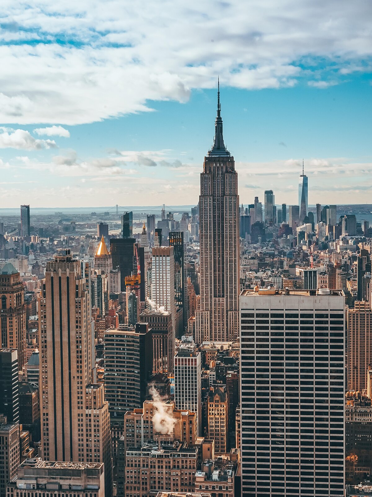 Panorama Manhattanu v New Yorku s Empire State Building uprostřed a One World Trade Center v pozadí.